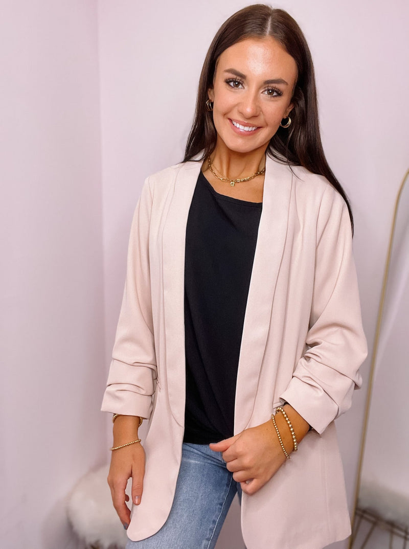 Blush blazer with ruched sleeves and front pockets. 