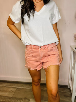 Pink high rise vintage shorts with frayed hem.