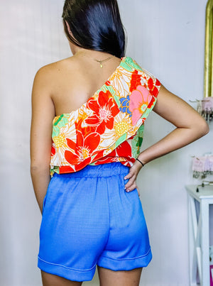 Floral print asymmetrical print one-shoulder ruffled top with an elasticized neckline.