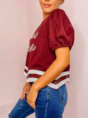 Maroon Touchdown sequined crop top with curved sequined hem.