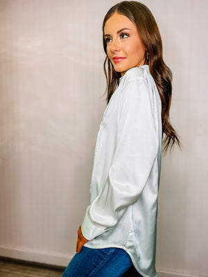 Basic black or white buttoned-down blouse with collar and buttoned cuffs. 97% polyester & 3% spandex.