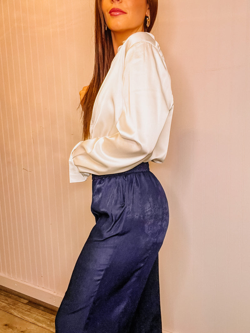 Navy side slit wide-leg pants with elastic waist and slant pockets. 